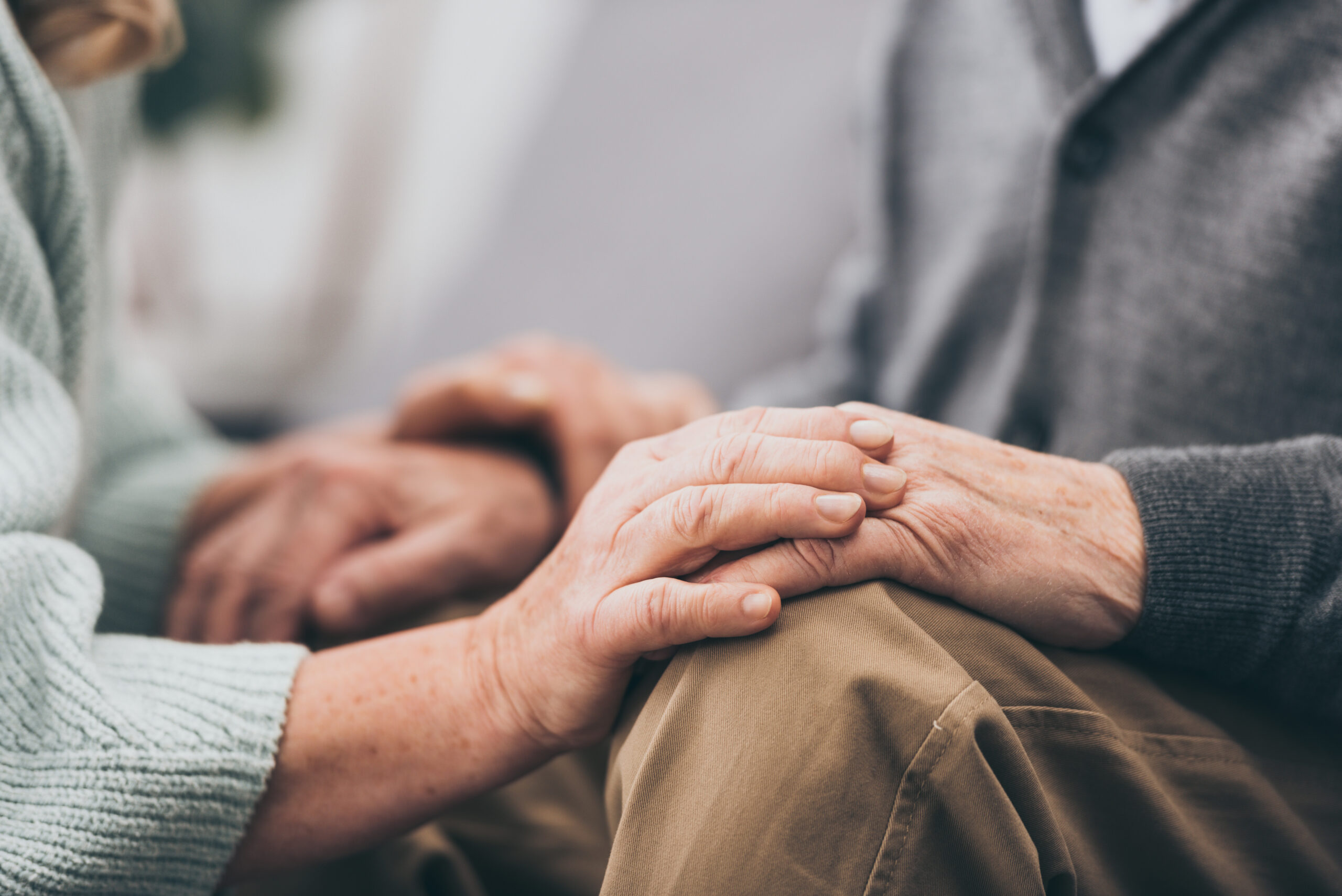Older couple holding each other’s hands.